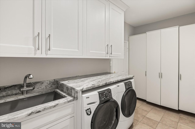 laundry room featuring sink, cabinets, and washer and dryer