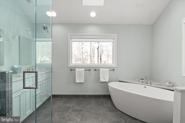 bathroom with vanity and a washtub