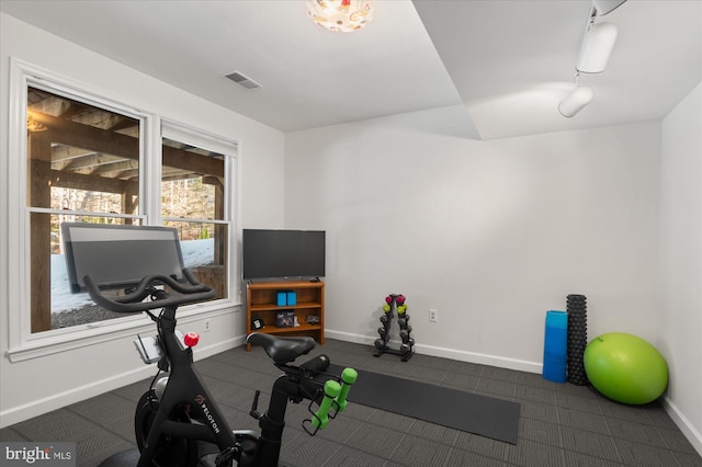 workout room featuring track lighting