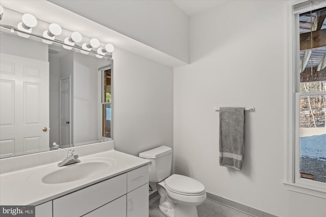 bathroom with vanity, toilet, and tile patterned flooring