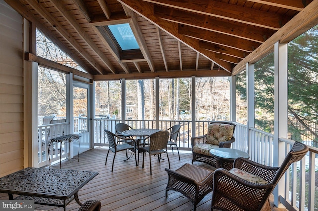 sunroom featuring vaulted ceiling with skylight