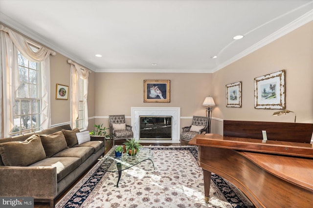 living room with hardwood / wood-style flooring, ornamental molding, and a high end fireplace