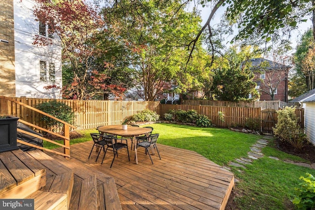 wooden deck featuring a yard