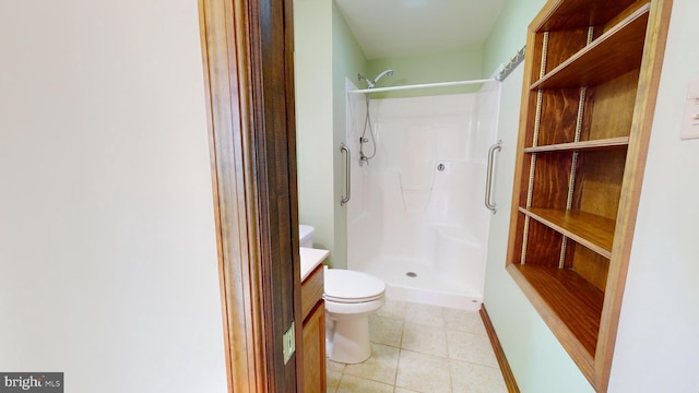 full bathroom with toilet, a shower stall, baseboards, and tile patterned flooring