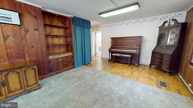 sitting room featuring light colored carpet, visible vents, and light wood-style floors