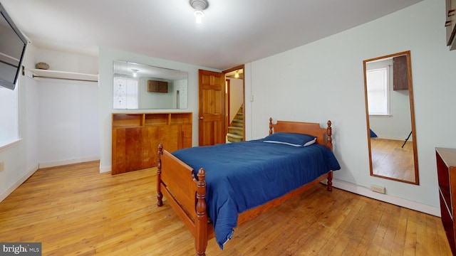 bedroom with baseboards and light wood-style floors