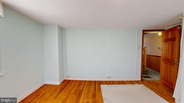 empty room featuring light wood-type flooring and baseboards