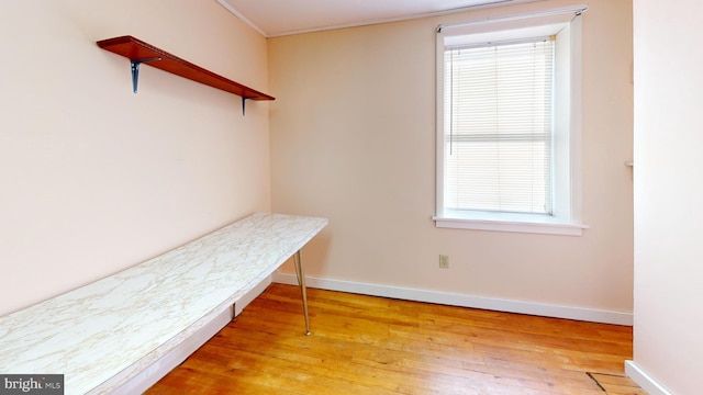 interior space featuring light wood-type flooring and baseboards