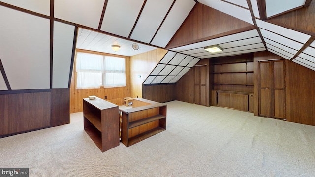 bonus room with light colored carpet, lofted ceiling, and wooden walls