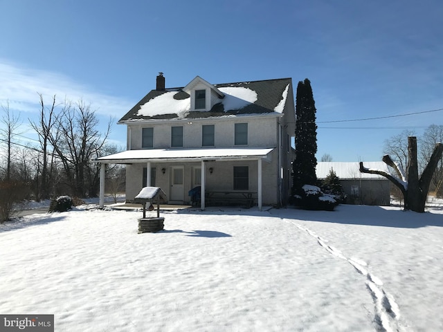 view of front of property with covered porch and a chimney