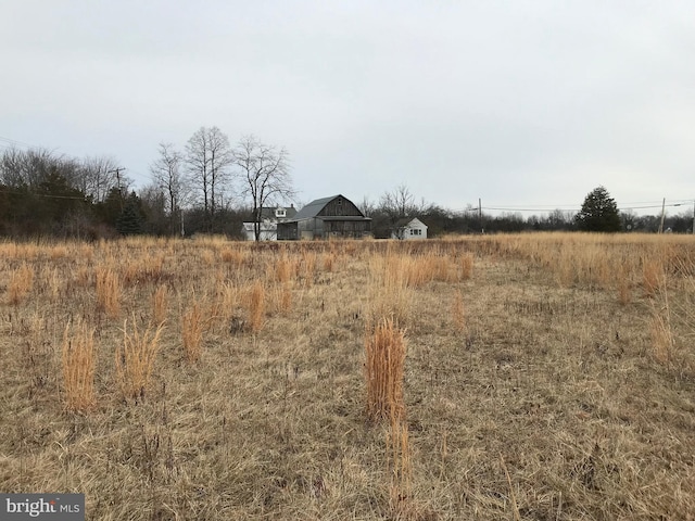 view of yard with a rural view