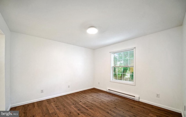 spare room with dark hardwood / wood-style floors and baseboard heating