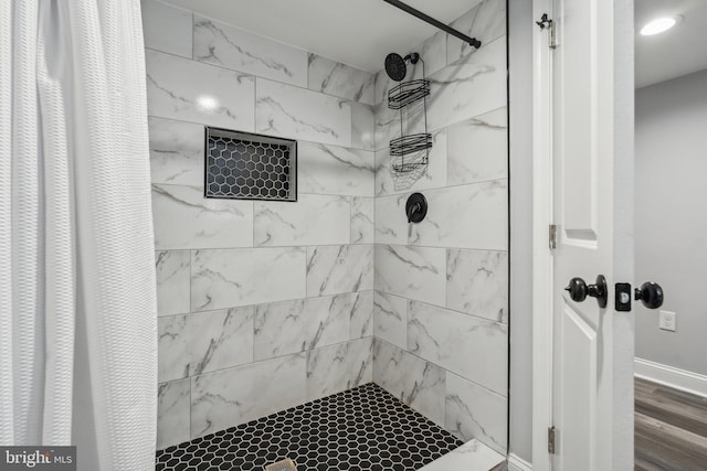 bathroom featuring wood-type flooring and walk in shower