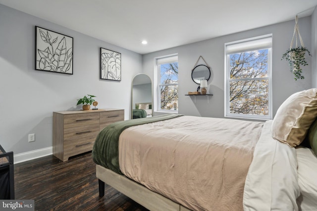 bedroom with dark hardwood / wood-style flooring