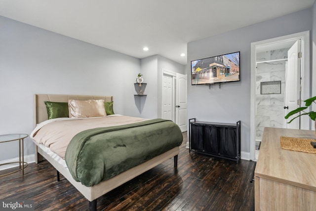 bedroom with connected bathroom and dark hardwood / wood-style floors