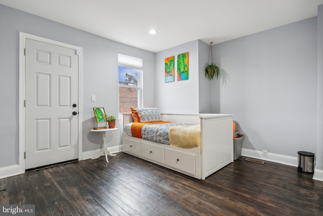 bedroom with dark hardwood / wood-style floors