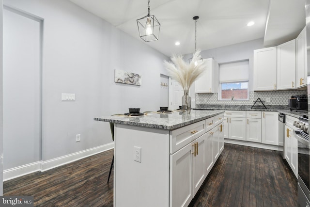 kitchen featuring a kitchen bar, white cabinets, dark hardwood / wood-style flooring, and a kitchen island