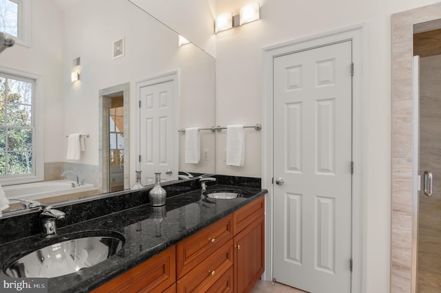 bathroom with vanity and independent shower and bath