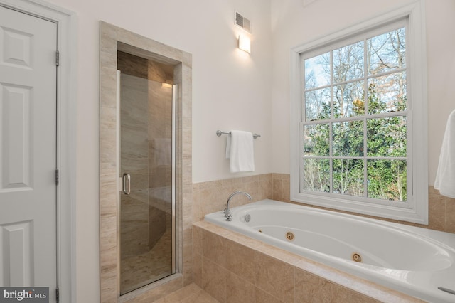 bathroom featuring separate shower and tub