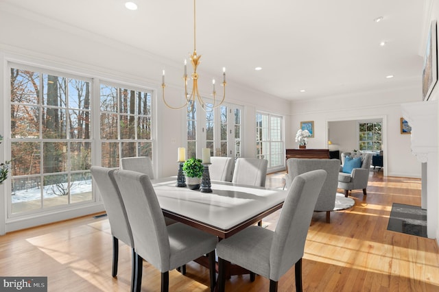 dining room featuring crown molding, a chandelier, and light hardwood / wood-style floors