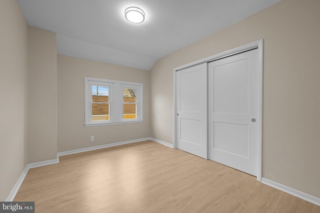 unfurnished bedroom with a closet and light hardwood / wood-style flooring