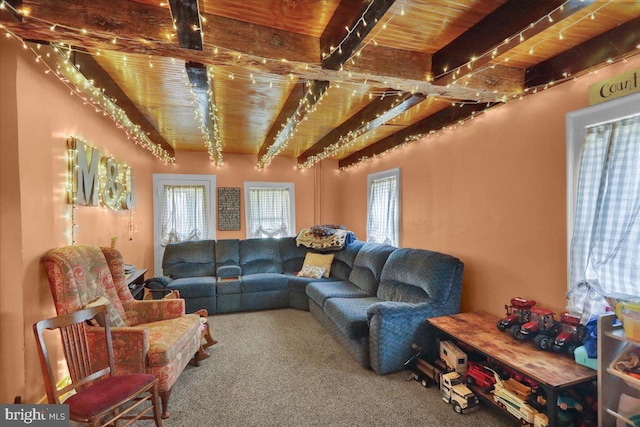 carpeted living room with beam ceiling and wooden ceiling