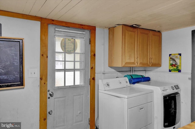 laundry room with cabinets, washer and clothes dryer, and wood ceiling