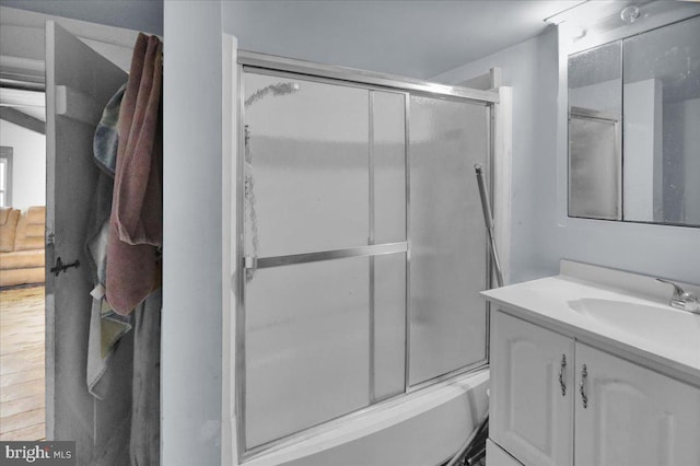 bathroom featuring vanity and enclosed tub / shower combo