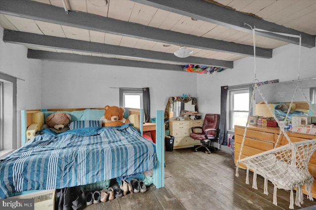 bedroom with hardwood / wood-style floors, lofted ceiling with beams, and multiple windows