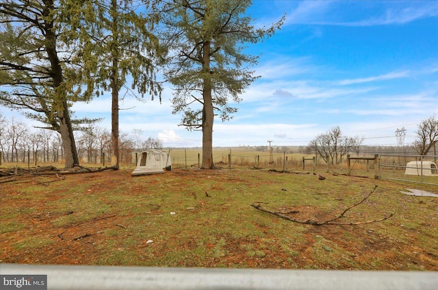 view of yard with a rural view