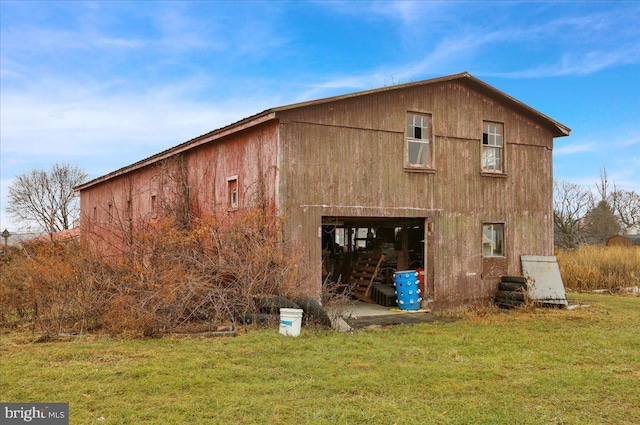 back of house with a lawn