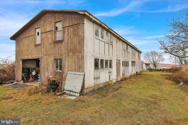 view of side of home with a yard