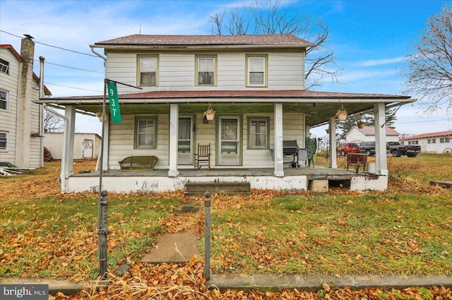 farmhouse with a front yard and a porch