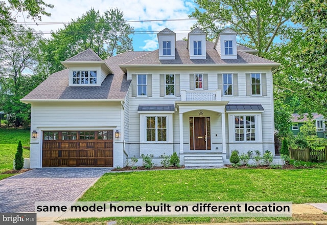 view of front of home featuring a garage and a front yard