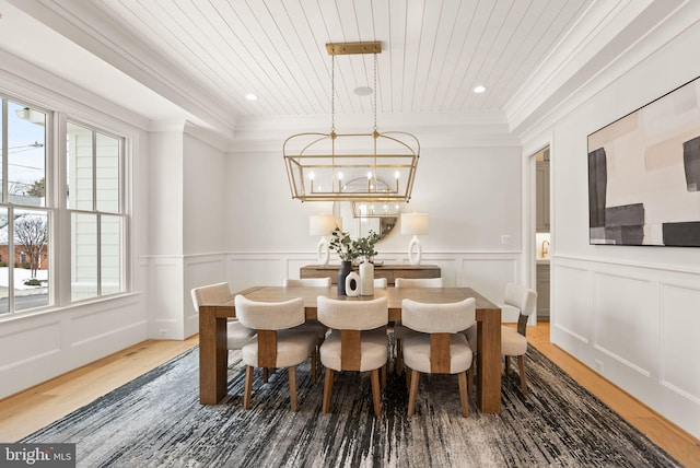 dining space with an inviting chandelier, wood ceiling, and hardwood / wood-style flooring