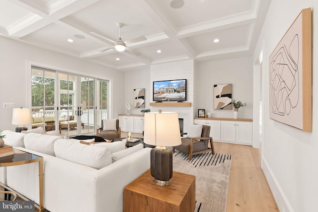 living room with ceiling fan, coffered ceiling, light hardwood / wood-style flooring, beamed ceiling, and a fireplace