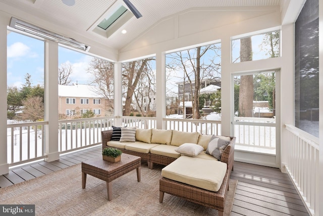 sunroom / solarium with vaulted ceiling with skylight