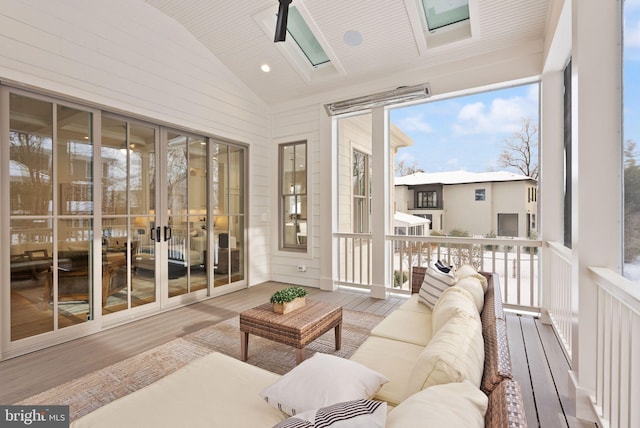 sunroom with lofted ceiling with skylight and wood ceiling