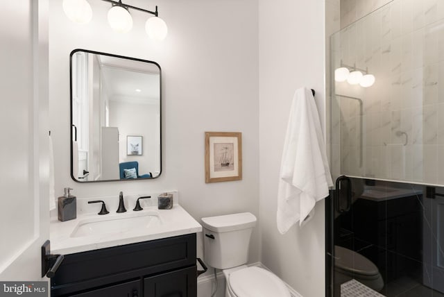 bathroom featuring toilet, vanity, and walk in shower