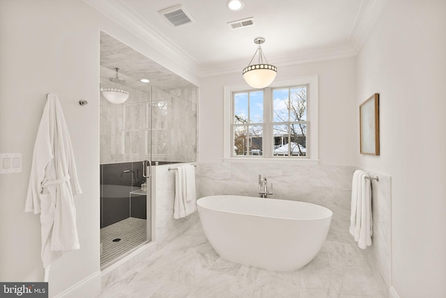 bathroom with crown molding, plus walk in shower, and tile walls