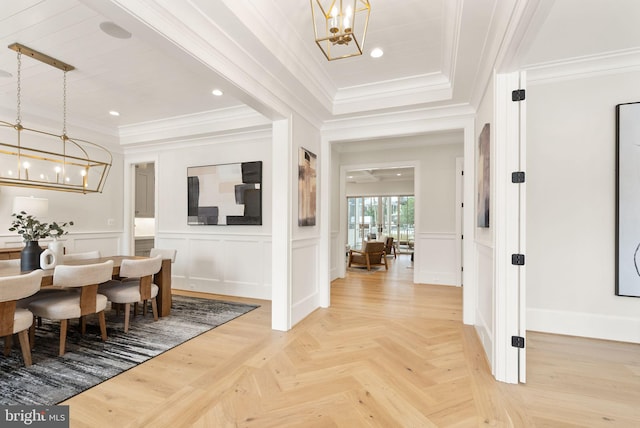 dining room with an inviting chandelier, ornamental molding, and parquet flooring