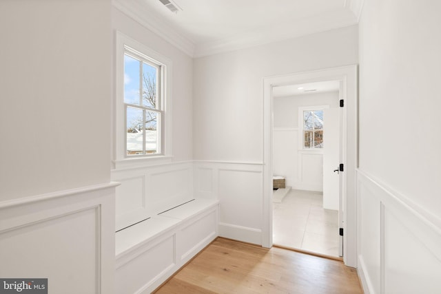 hallway featuring crown molding and light hardwood / wood-style floors