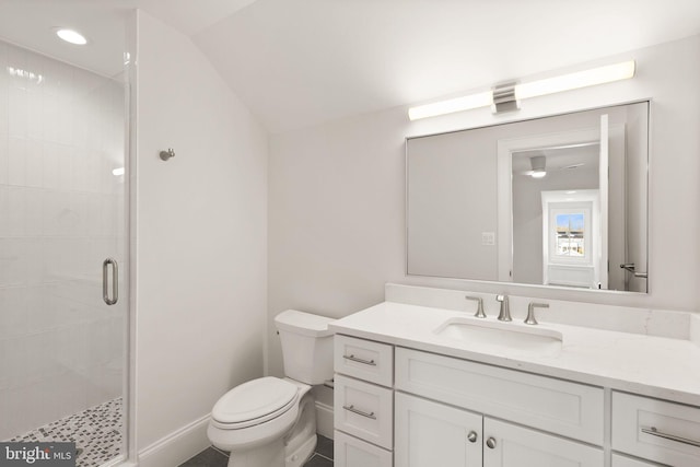 bathroom with a shower with door, vanity, and toilet