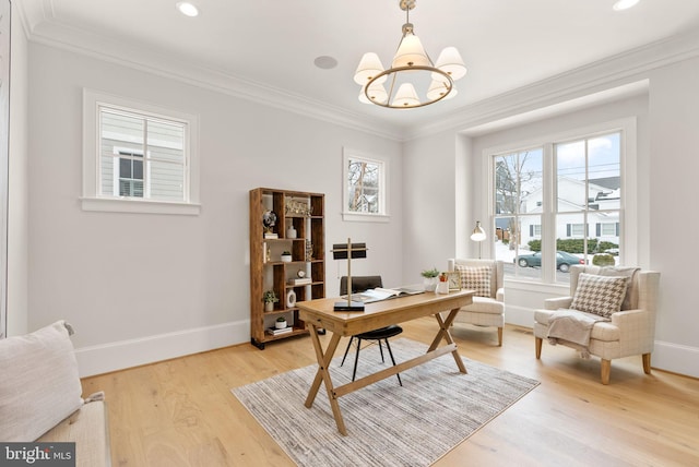 home office with light hardwood / wood-style flooring, ornamental molding, and a notable chandelier