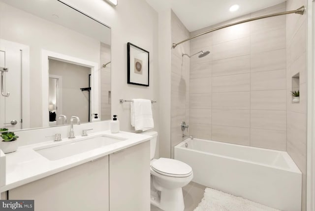 full bathroom with tile patterned floors, toilet, vanity, and tiled shower / bath