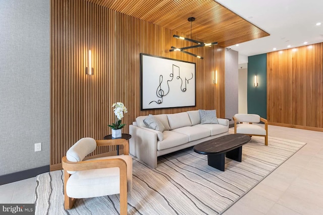 living room with a chandelier, wooden walls, and wooden ceiling