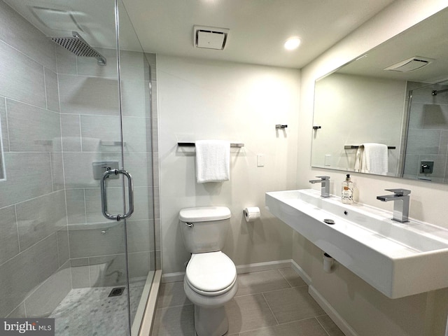 2201 L St NW Unit 906, Washington, DC 20037 - bathroom with toilet, a stall shower, tile patterned floors, baseboards, and recessed lighting