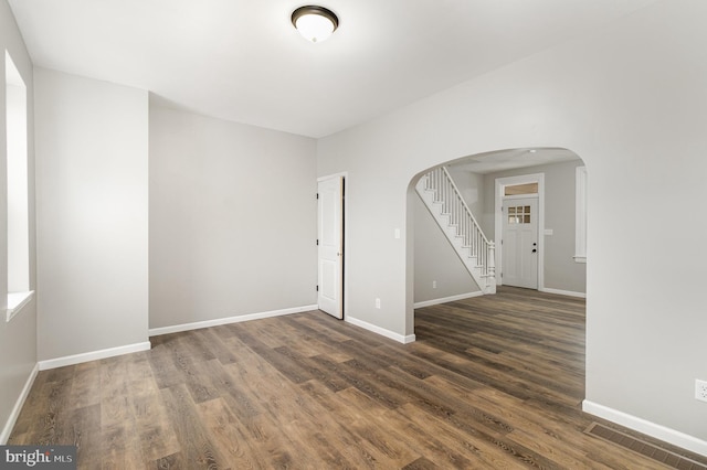 spare room with dark wood-type flooring