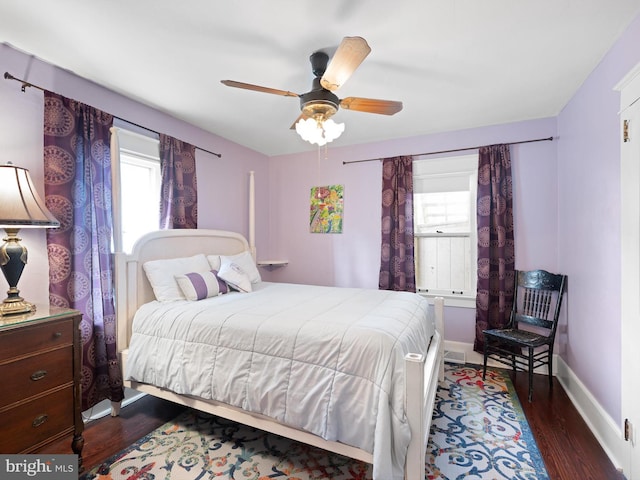 bedroom with ceiling fan and dark hardwood / wood-style flooring