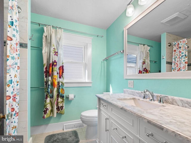 bathroom with tile patterned flooring, vanity, toilet, and walk in shower